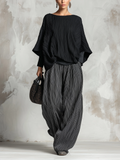 Set a due pezzi con top ampio plissettato e pantaloni a gamba larga